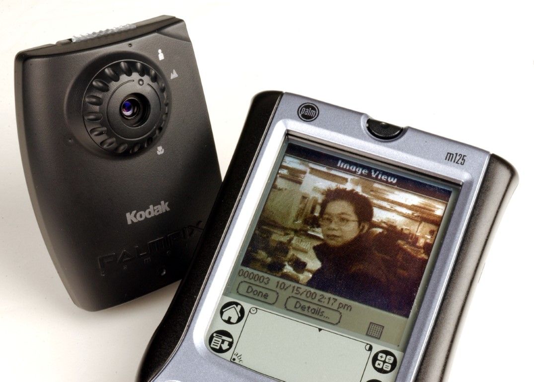 A clip-on Kodac PalmPix digital camera for a Palm m125 handheld computer.